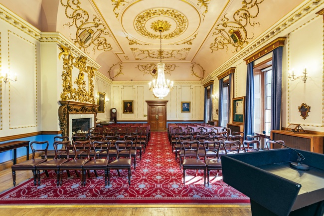 Ornate room at Stationers' Hall set out with chairs and a lectern